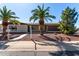 Charming single-story home with desert landscaping and mature palm trees in the front yard at 6409 E Duncan St, Mesa, AZ 85205