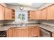 Kitchen featuring wood cabinets, stainless steel appliances, and a window with a view at 6409 E Duncan St, Mesa, AZ 85205