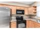Close up of the kitchen featuring stainless steel refrigerator, oven, and microwave at 6409 E Duncan St, Mesa, AZ 85205