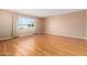 Bright living room with neutral paint, wood floors, and a large window at 6409 E Duncan St, Mesa, AZ 85205