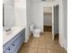The bathroom features a vanity with storage space, tile floors, and natural light at 7009 W Lincoln St, Peoria, AZ 85345