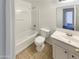 Clean bathroom featuring a shower-tub combo, toilet, and vanity with a sink at 7009 W Lincoln St, Peoria, AZ 85345