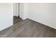 This bedroom features modern gray wood-look floors and a walk-in closet at 7009 W Lincoln St, Peoria, AZ 85345