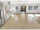 An open-concept kitchen boasts white cabinets, stainless steel appliances, and access to the home's backyard at 7009 W Lincoln St, Peoria, AZ 85345