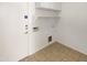 A convenient laundry room featuring built-in shelving, ample storage, and utility connections at 7009 W Lincoln St, Peoria, AZ 85345