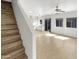 Open-concept living space with wooden staircase, vinyl floors, and a well-lit atmosphere at 7009 W Lincoln St, Peoria, AZ 85345