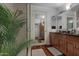 Stylish bathroom showcasing a glass-enclosed shower and a double sink vanity with wood cabinetry at 7147 E Rancho Vista Dr # 4007, Scottsdale, AZ 85251