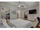 Bright bedroom featuring a ceiling fan, artwork, and ensuite bathroom and a glimpse into a second room at 7147 E Rancho Vista Dr # 4007, Scottsdale, AZ 85251