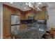 This kitchen is equipped with granite counters, stainless steel appliances, and wooden cabinets at 7147 E Rancho Vista Dr # 4007, Scottsdale, AZ 85251