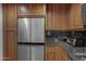 Stainless steel refrigerator and wooden cabinetry accents this kitchen's modern design at 7147 E Rancho Vista Dr # 4007, Scottsdale, AZ 85251
