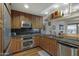 Modern kitchen with granite counters, wood cabinets, and a stainless steel appliance package at 7147 E Rancho Vista Dr # 4007, Scottsdale, AZ 85251