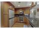 Well-equipped kitchen features wood cabinets, granite counters, and stainless steel appliances at 7147 E Rancho Vista Dr # 4007, Scottsdale, AZ 85251