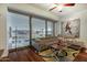 Bright living room featuring a large window, hardwood floors, and a comfortable sectional sofa at 7147 E Rancho Vista Dr # 4007, Scottsdale, AZ 85251