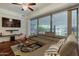 Open living room with a large sectional, entertainment center, and floor-to-ceiling windows at 7147 E Rancho Vista Dr # 4007, Scottsdale, AZ 85251