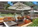 Stylish patio featuring comfortable seating, modern tables, umbrellas and views of lush greenery and a water feature at 7147 E Rancho Vista Dr # 4007, Scottsdale, AZ 85251