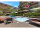 Community pool and hot tub surrounded by patios and lush landscaping at this luxury condominium property at 7147 E Rancho Vista Dr # 4007, Scottsdale, AZ 85251