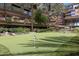 Well-manicured putting green surrounded by lush landscaping at this beautiful multi-story condo complex at 7147 E Rancho Vista Dr # 4007, Scottsdale, AZ 85251