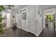 Hallway with a sliding barn door, stylish chandelier, and dark hardwood floors at 7157 E Rancho Vista Dr # 6011, Scottsdale, AZ 85251