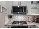 Close-up of a modern kitchen showcasing stainless steel appliances and a decorative backsplash at 7157 E Rancho Vista Dr # 6011, Scottsdale, AZ 85251