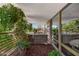 This covered patio features ample foliage, an outdoor lounge area, and floor-to-ceiling windows at 7157 E Rancho Vista Dr # 6011, Scottsdale, AZ 85251