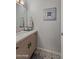 This is a stunning powder room with decorative tile floor and elegant mirror fixture at 7157 E Rancho Vista Dr # 6011, Scottsdale, AZ 85251