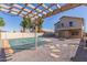 Great backyard featuring a covered pool, built-in firepit, and a pergola covered in lights at 7830 S 26Th St, Phoenix, AZ 85042