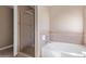 Bathroom featuring separate shower and tub with tile surround at 7830 S 26Th St, Phoenix, AZ 85042