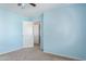 Bedroom with light blue walls, carpet flooring and access to an adjacent room at 7830 S 26Th St, Phoenix, AZ 85042