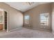 Cozy bedroom with carpet, two windows, and a neutral color scheme at 7830 S 26Th St, Phoenix, AZ 85042