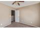 Bedroom with neutral walls, ceiling fan, and a doorway to another room at 7830 S 26Th St, Phoenix, AZ 85042