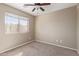 Bedroom featuring a large window, neutral carpet, and electrical outlets at 7830 S 26Th St, Phoenix, AZ 85042