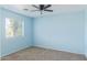 Bedroom featuring a large window offering natural light and a ceiling fan at 7830 S 26Th St, Phoenix, AZ 85042