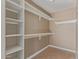 Walk-in closet with built-in shelving and hanging rods offers ample storage space at 7830 S 26Th St, Phoenix, AZ 85042