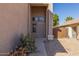 Inviting front entrance featuring neutral stucco, desert landscaping, and a decorative front door at 7830 S 26Th St, Phoenix, AZ 85042