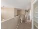 Upstairs hallway with carpeted floors and neutral paint leads to various rooms at 7830 S 26Th St, Phoenix, AZ 85042