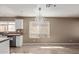 Bright kitchen featuring tile floors, white cabinets, and a chandelier-style light fixture at 7830 S 26Th St, Phoenix, AZ 85042