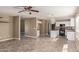 Open floor plan with living area and kitchen, featuring tile floors and natural lighting at 7830 S 26Th St, Phoenix, AZ 85042