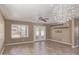Spacious living room with tile floors, a ceiling fan, and access to the backyard through double doors at 7830 S 26Th St, Phoenix, AZ 85042