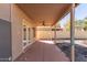 Covered back patio with ceiling fan and access to the backyard at 7830 S 26Th St, Phoenix, AZ 85042