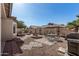 Backyard oasis with patio seating, a fire pit, and thoughtfully designed landscaping at 8734 S 57Th Dr, Laveen, AZ 85339