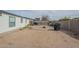 Spacious backyard with fire pit area, grill, and neutral desert landscaping at 9709 E Empress Ave, Mesa, AZ 85208