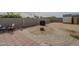 Backyard featuring a large fire pit, block fence, and various entertaining spaces at 9709 E Empress Ave, Mesa, AZ 85208