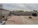 A well-kept backyard has a mix of brick and stone and a dog run at 9709 E Empress Ave, Mesa, AZ 85208