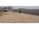 Large, flat backyard with block fence and minimal desert landscaping at 9709 E Empress Ave, Mesa, AZ 85208