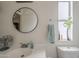 Bright bathroom features vanity, round mirror and a toilet at 9709 E Empress Ave, Mesa, AZ 85208