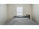 Bedroom featuring a bed with natural light coming through the window with blinds at 9709 E Empress Ave, Mesa, AZ 85208