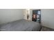 A bedroom featuring a bed, television, and a glimpse into the dining area at 9709 E Empress Ave, Mesa, AZ 85208