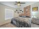 Comfortable bedroom features carpet, brick accent wall, and ceiling fan at 9709 E Empress Ave, Mesa, AZ 85208