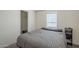 A neatly made bed sits in a room brightened by natural light from a window at 9709 E Empress Ave, Mesa, AZ 85208