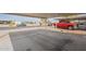 View of a carport and driveway area showcasing parking space and community street at 9709 E Empress Ave, Mesa, AZ 85208